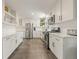 Bright kitchen featuring white cabinetry, stainless steel appliances, and contemporary finishes, ready for move-in at 13402 W 24Th Pl, Golden, CO 80401