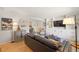 Open-concept living room with hardwood floors, custom built-ins, and stylish furnishings; perfect for entertaining at 13402 W 24Th Pl, Golden, CO 80401