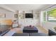 Inviting living room featuring custom built-ins, stylish decor, and a large window with abundant natural light at 13402 W 24Th Pl, Golden, CO 80401