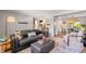 Comfortable living room flowing into the dining area, featuring modern decor and hardwood floors at 13402 W 24Th Pl, Golden, CO 80401