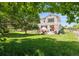 Expansive lawn and patio area with mature trees perfect for outdoor entertaining and relaxation at 17298 E Lake Pl, Aurora, CO 80016
