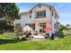 Exterior view of a charming two-story home with a patio, decorative umbrellas, and lush landscaping at 17298 E Lake Pl, Aurora, CO 80016