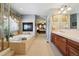Upscale bathroom with tub, walk-in shower, fireplace and dual sink vanity at 17298 E Lake Pl, Aurora, CO 80016