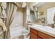 Elegant bathroom featuring tiled walls, a decorative mirror, and vanity cabinets for a luxurious and spa-like experience at 17298 E Lake Pl, Aurora, CO 80016