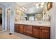 Bathroom featuring double sink vanity with wood cabinets and framed mirror at 17298 E Lake Pl, Aurora, CO 80016
