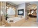 Bathroom featuring jetted tub with fireplace, tiled surround, and glass-enclosed shower at 17298 E Lake Pl, Aurora, CO 80016