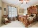 Bedroom featuring carved wood bed frame, picture window, and rocking chair at 17298 E Lake Pl, Aurora, CO 80016
