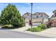 Well-maintained home featuring a spacious driveway, lawn, and lush trees at 17298 E Lake Pl, Aurora, CO 80016