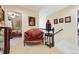 Cozy hallway seating with ornate armchair, table lamp, and view to bedroom at 17298 E Lake Pl, Aurora, CO 80016