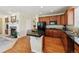 Modern kitchen boasting stainless steel appliances, a functional island, and easy access to both the living room and dining area at 17298 E Lake Pl, Aurora, CO 80016