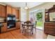 Sunlit kitchen and dining area featuring wood cabinets, an oven, and sliding glass doors to the backyard and patio at 17298 E Lake Pl, Aurora, CO 80016