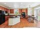 Well-appointed kitchen with wood cabinets, sleek appliances, an island, and an adjacent dining area with backyard access at 17298 E Lake Pl, Aurora, CO 80016