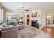 Inviting living room featuring a stone fireplace and modern sectional sofa at 17298 E Lake Pl, Aurora, CO 80016