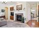 Inviting living room featuring a stone fireplace, built-in cabinets, and an open layout for seamless entertaining at 17298 E Lake Pl, Aurora, CO 80016