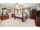 Spacious primary bedroom featuring four-poster bed, ceiling fan and window with curtains at 17298 E Lake Pl, Aurora, CO 80016
