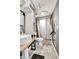Well-lit bathroom featuring a pedestal sink and a tiled shower at 8430 Madison Way, Denver, CO 80229