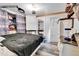 Comfortable bedroom featuring a large bed, vintage-style dresser and a built-in closet at 8430 Madison Way, Denver, CO 80229