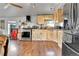 Functional kitchen featuring wood cabinets and appliances with laminated wood flooring at 8430 Madison Way, Denver, CO 80229
