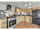 Well-equipped kitchen with stainless steel appliances and warm-toned wood cabinetry at 8430 Madison Way, Denver, CO 80229