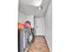 Functional laundry room area featuring a stacked washer and dryer on a dark laminate floor at 8430 Madison Way, Denver, CO 80229