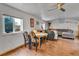 The living room features a dining area with a ceiling fan and windows for natural light at 8430 Madison Way, Denver, CO 80229