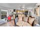 An open-concept living area with a kitchen featuring wooden cabinets and a black refrigerator at 8430 Madison Way, Denver, CO 80229