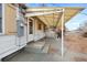 Covered back porch with awning, concrete steps, and entrance door at 1994 Macon St, Aurora, CO 80010