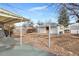 View of the backyard with small detached garage and covered porch at 1994 Macon St, Aurora, CO 80010