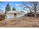 Leaf-covered backyard featuring a detached garage, shed and plenty of room to roam at 1994 Macon St, Aurora, CO 80010