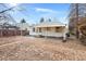 View of the backyard with detached garage and covered back patio at 1994 Macon St, Aurora, CO 80010