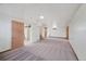 View of the finished basement with painted walls, neutral carpet, and access to utility area at 1994 Macon St, Aurora, CO 80010