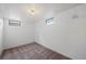 Small finished basement room with carpet and two windows for natural light at 1994 Macon St, Aurora, CO 80010