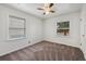 Well-lit bedroom with neutral carpet, ceiling fan, and two windows at 1994 Macon St, Aurora, CO 80010