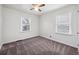 Bright bedroom with neutral carpet, a ceiling fan, and two windows at 1994 Macon St, Aurora, CO 80010