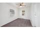Bedroom with neutral carpet, a ceiling fan, and two windows at 1994 Macon St, Aurora, CO 80010