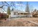Charming single-story home with a covered patio, set in a spacious, leaf-strewn yard at 1994 Macon St, Aurora, CO 80010