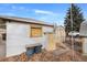 External shot showing the rear of the garage with a shed and access to alleyway at 1994 Macon St, Aurora, CO 80010