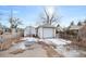 Garage and shed, secured by a chain link fence, off of a snow-patched alleyway at 1994 Macon St, Aurora, CO 80010