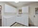 Updated kitchen with white cabinets, subway tile backsplash, and modern countertops at 1994 Macon St, Aurora, CO 80010