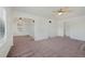 Bright living room with open layout featuring neutral paint, carpet, and ceiling fan at 1994 Macon St, Aurora, CO 80010