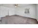 Spacious living room with neutral carpet, ceiling fan, and ample natural light at 1994 Macon St, Aurora, CO 80010