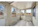 Well-lit porch features brick accent wall, wood-look floor, and multiple windows at 1994 Macon St, Aurora, CO 80010