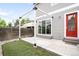 Backyard featuring a concrete patio, turf, string lights, and sliding glass doors at 4730 S Acoma St, Englewood, CO 80110