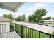 Balcony view of the street with lush trees and parked vehicles at 4730 S Acoma St, Englewood, CO 80110