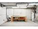 Spacious unfinished basement features concrete flooring, workbench, and visible utility connections at 4730 S Acoma St, Englewood, CO 80110