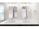 Bright bathroom with double sinks, quartz countertop, and modern light fixtures at 4730 S Acoma St, Englewood, CO 80110