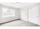 Minimalist bedroom with carpet, natural light from window, and double-door closet for storage at 4730 S Acoma St, Englewood, CO 80110