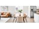 Dining area featuring a wooden table with seating for four, with decor, and stainless steel refrigerator at 4730 S Acoma St, Englewood, CO 80110