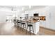 Bright kitchen featuring an island with barstool seating, stainless steel appliances, and white cabinetry at 4730 S Acoma St, Englewood, CO 80110