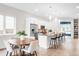 An open floor plan kitchen featuring stainless steel appliances, an island, a breakfast nook, and modern lighting at 4730 S Acoma St, Englewood, CO 80110